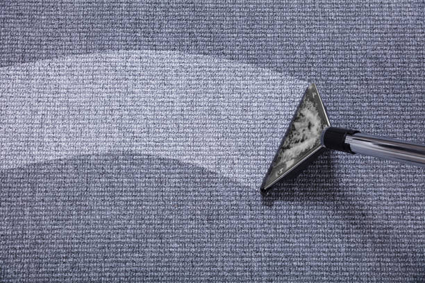 close up of a vacuum cleaner over grey carpet