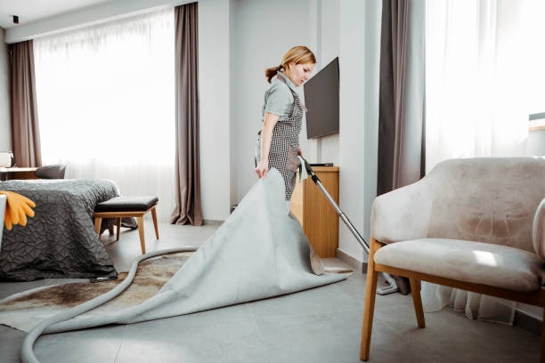 maid vacuuming hotel room